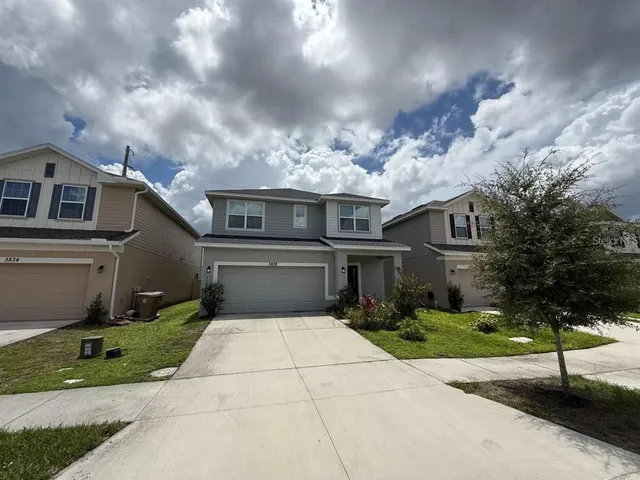 a front view of a house with yard