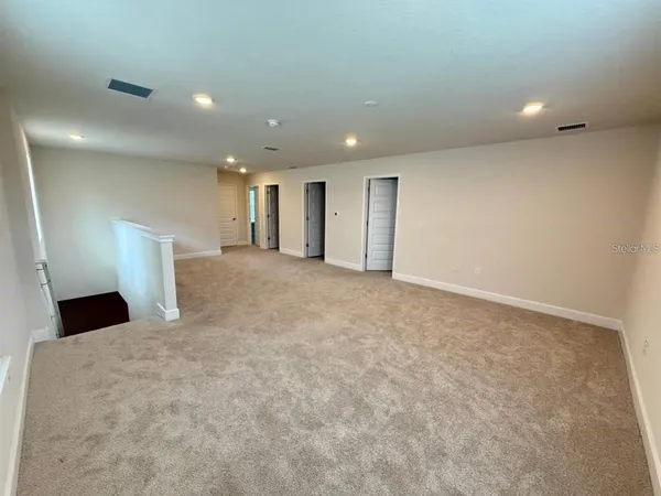 a view of a hallway to a bedroom and a livingroom