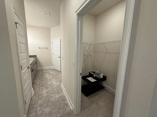 a bathroom with a glass shower door and a toilet
