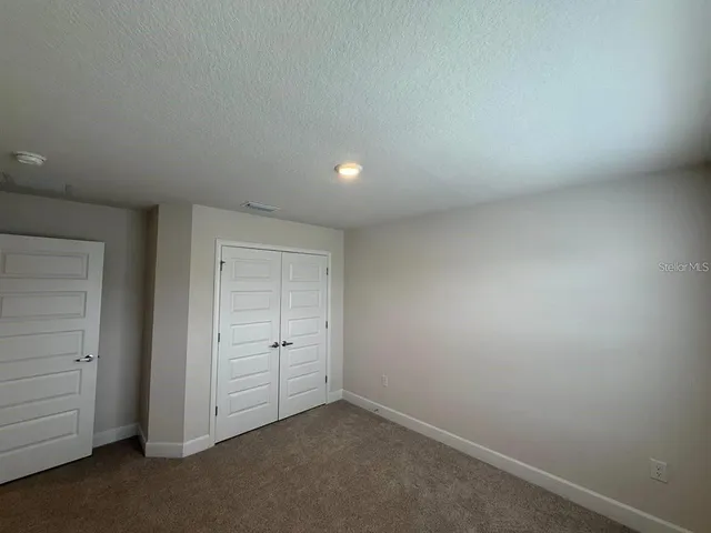 an empty room with closet area
