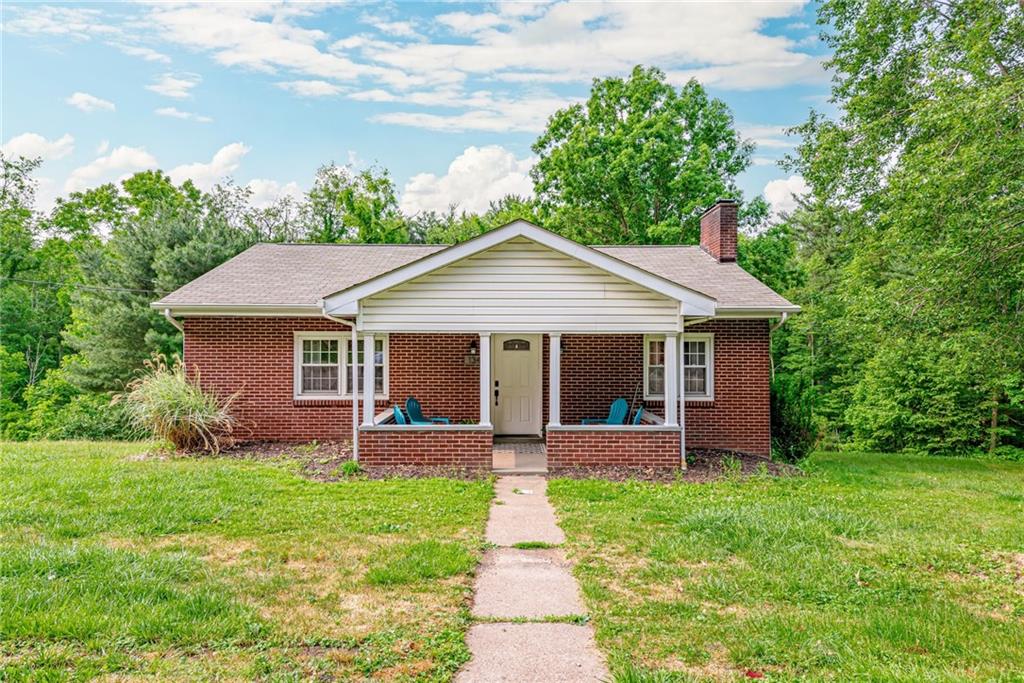a front view of house with a garden and patio