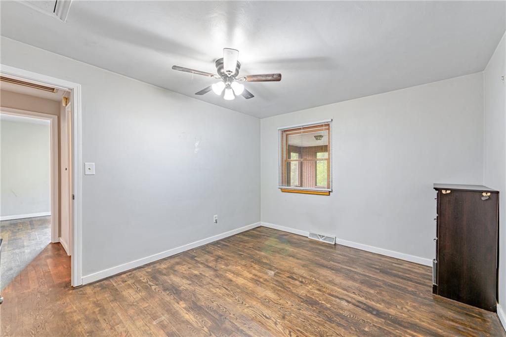 134 Story Road Export, PA 15632 - Photo 19 of 23 a view of empty room with wooden floor and fan