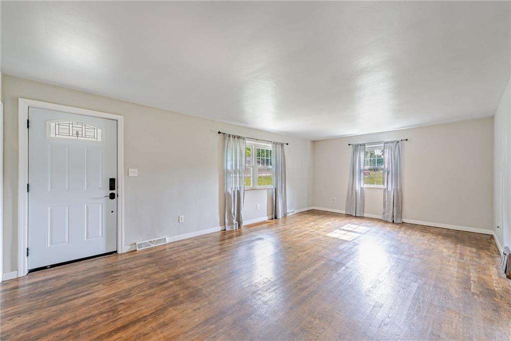 134 Story Road Export, PA 15632 - Photo 6 of 23 an empty room with wooden floor & windows