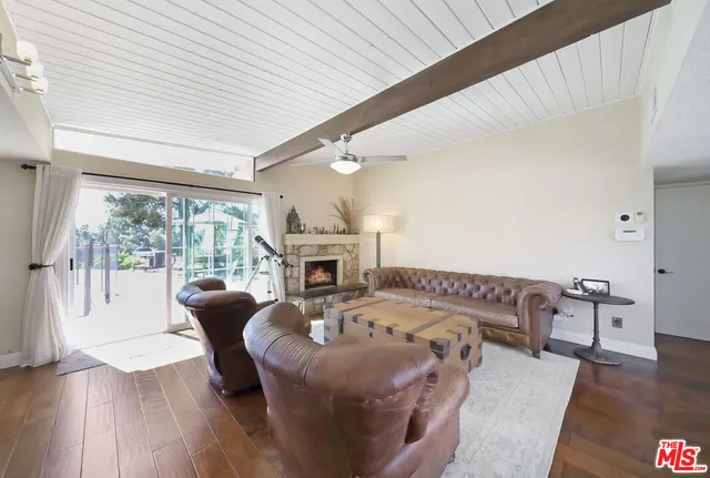 a living room with furniture fireplace and a table