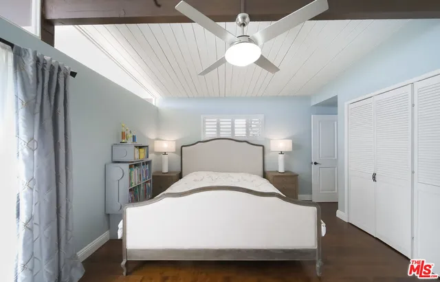 a large bed sitting in a bedroom next to a bathroom