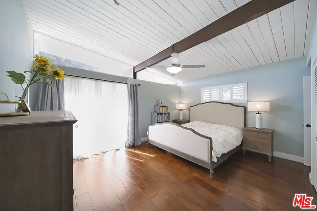 a bedroom with a bed and a potted plant