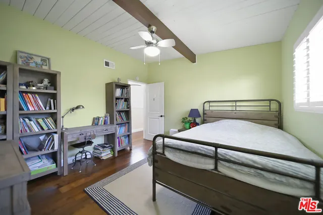 a bedroom with furniture and a book shelf