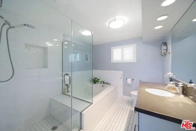 a bathroom with a granite countertop sink a shower and a mirror