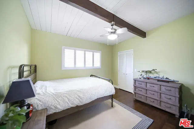 a bedroom with a bed dresser and a window