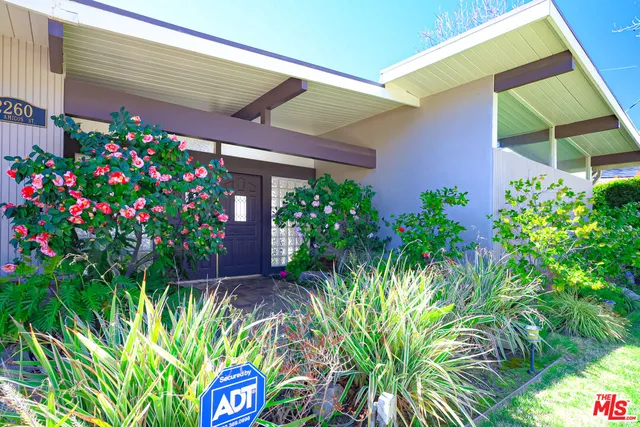 a flower plants in front of a house