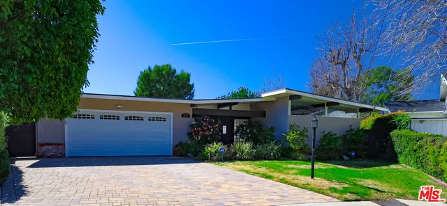 a front view of house with garden