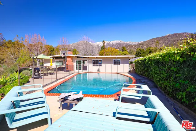 a view of swimming pool with lounge chair