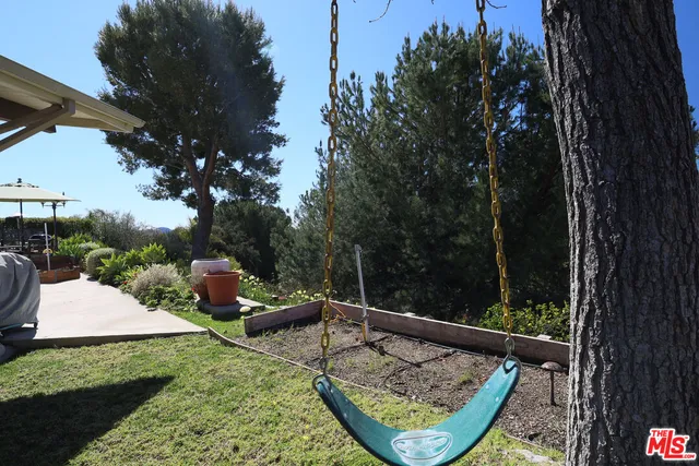 a view of a two chair and tables in the patio