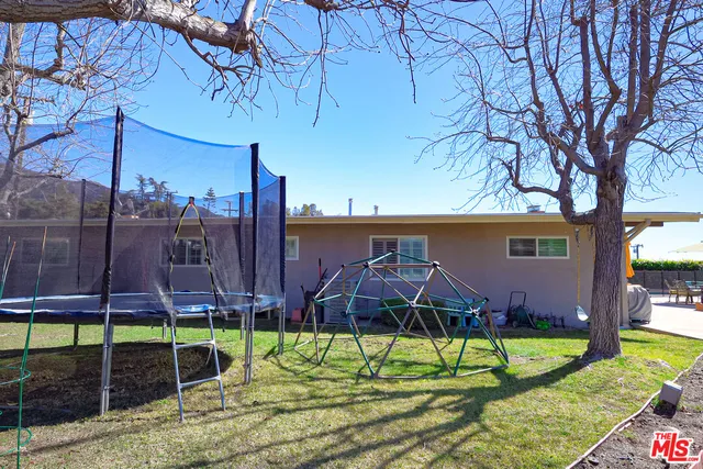 a view of house with a yard