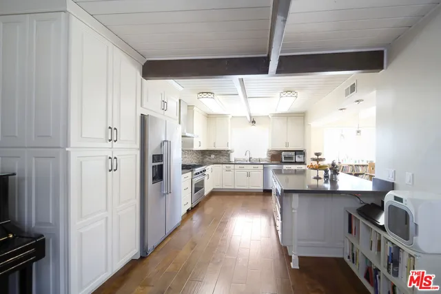 a kitchen with stainless steel appliances a sink and cabinets
