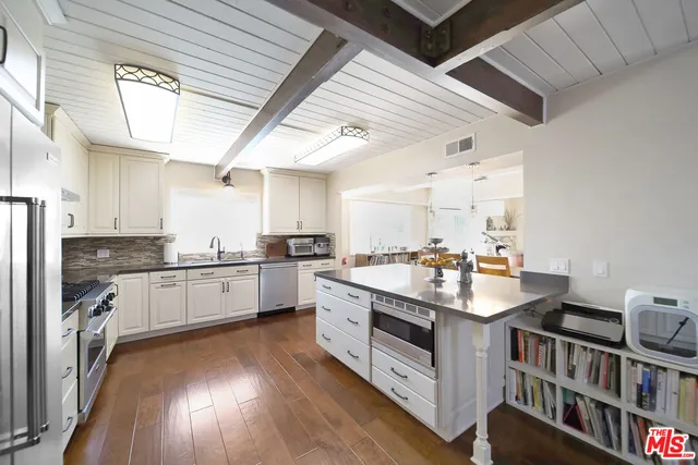 a kitchen with stainless steel appliances granite countertop a stove and a refrigerator