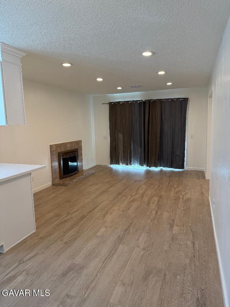 45303 Lorimer Avenue Lancaster, CA 93534 - Photo 6 of 15 a view of an empty room with a fireplace
