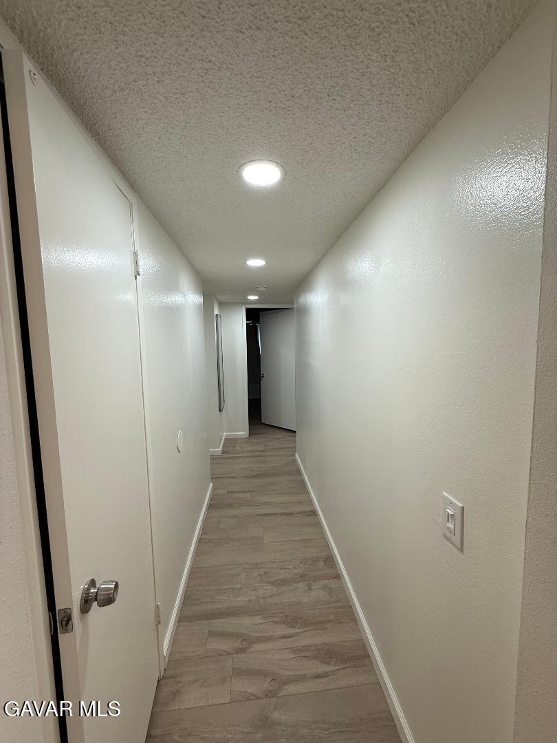 45303 Lorimer Avenue Lancaster, CA 93534 - Photo 8 of 15 a view of hallway with wooden floor