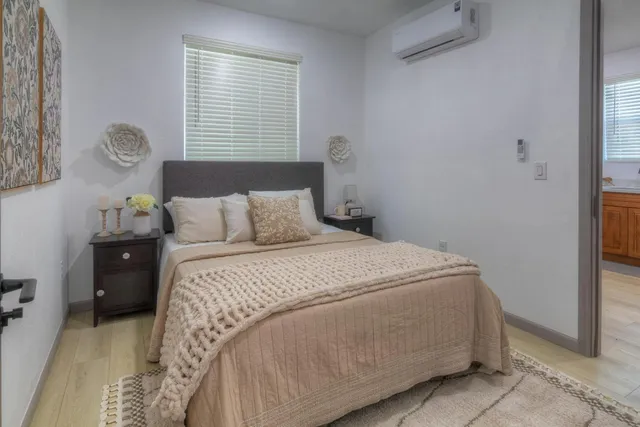 a bedroom with a bed and a window