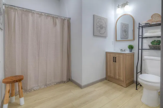 a bathroom with a toilet a sink and mirror