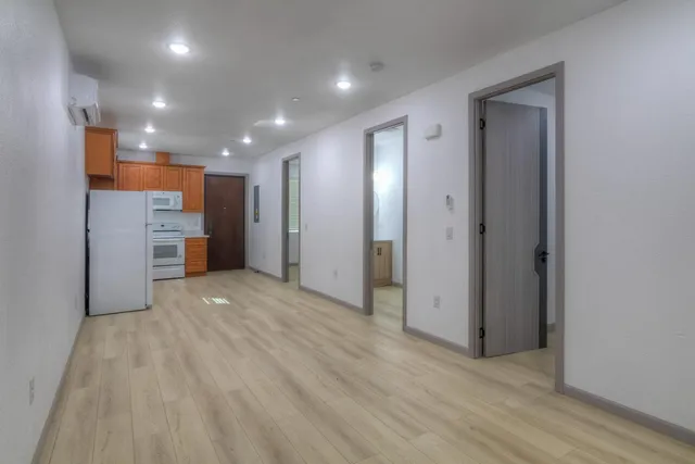 a kitchen with a refrigerator sink and cabinets