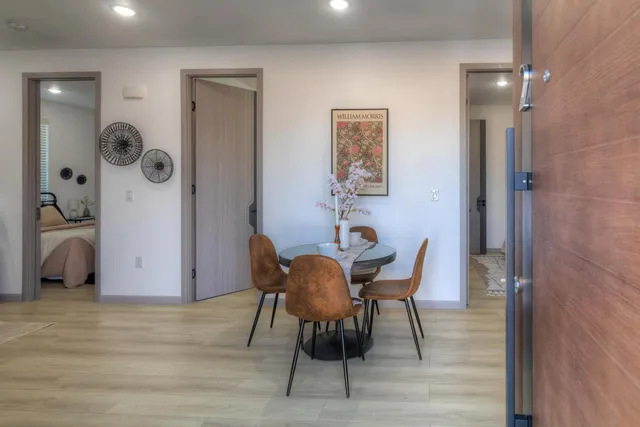 a view of a dining room with furniture and wooden floor