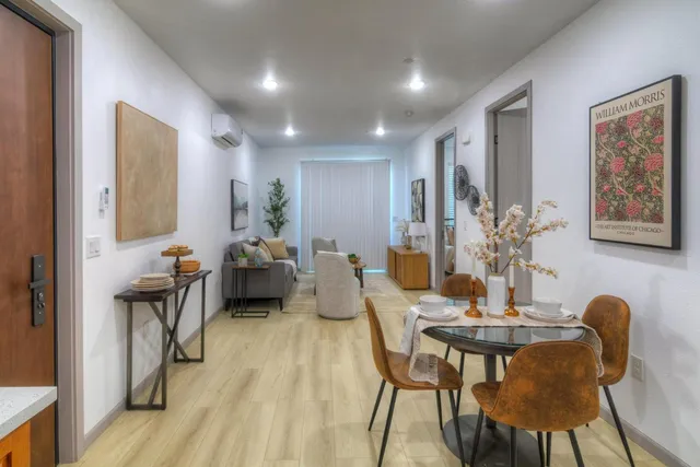 a view of a dining room with furniture and wooden floor