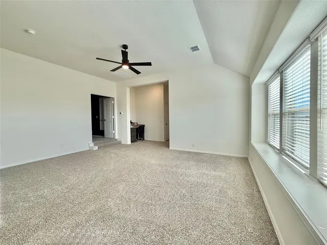 an empty room with a empty space and a ceiling fan