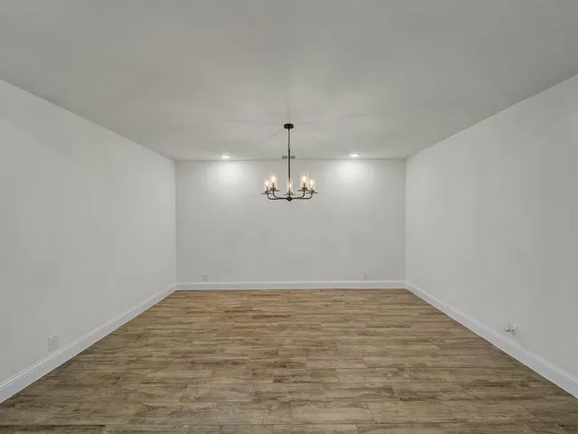 a view of a room with wooden floor and window