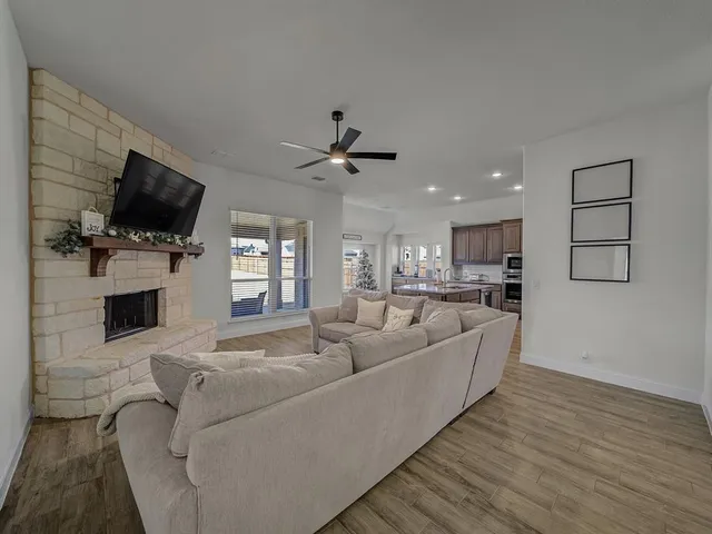 a living room with furniture fireplace and flat screen tv