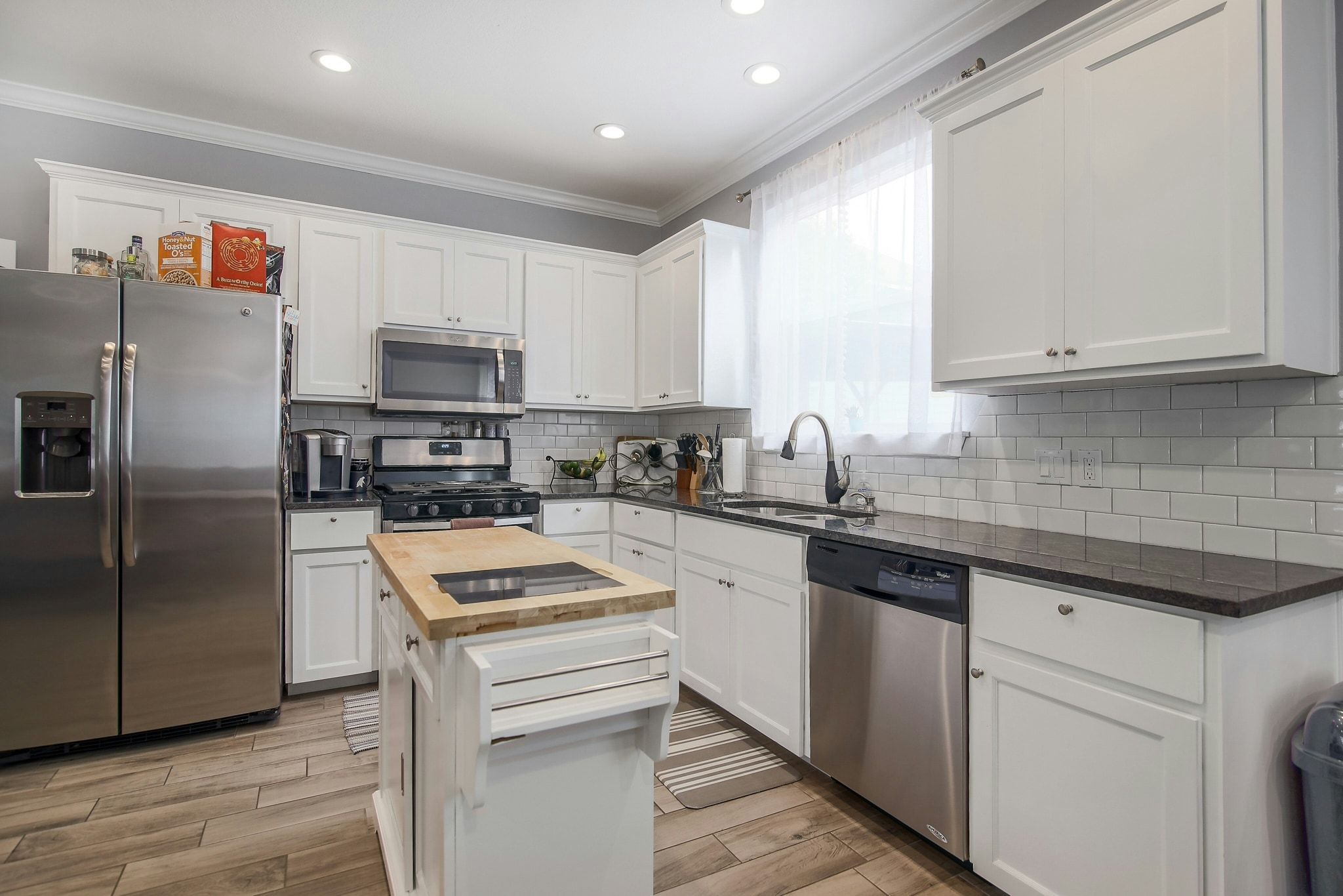 2109 Maxwell Lane, Unit A Austin, TX 78741 - Photo 12 of 27 a kitchen with a refrigerator sink and cabinets