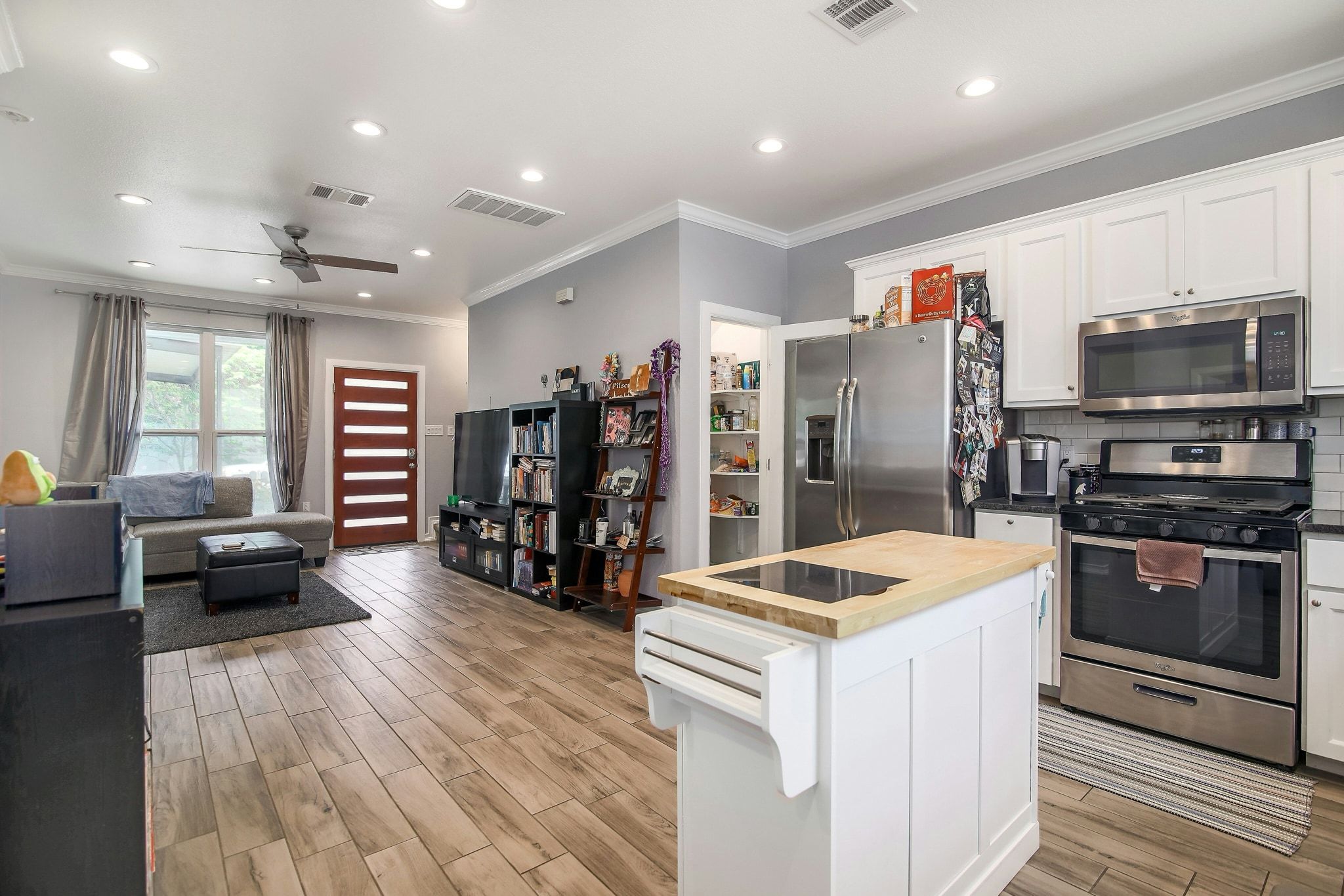 2109 Maxwell Lane, Unit A Austin, TX 78741 - Photo 27 of 27 a kitchen with stainless steel appliances granite countertop a refrigerator oven a sink dishwasher and a stove with wooden floor
