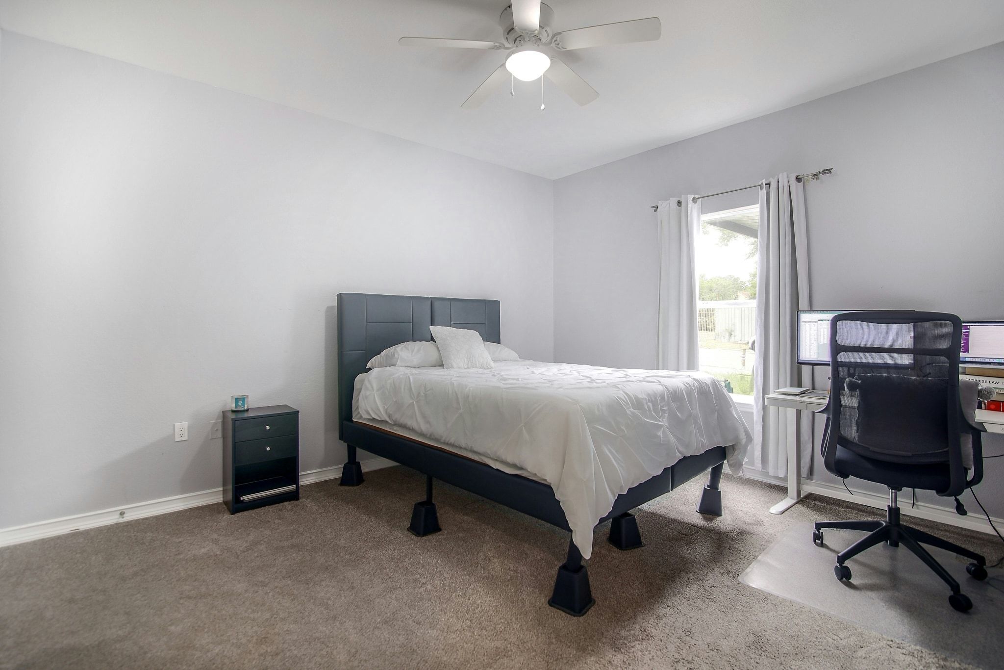 2109 Maxwell Lane, Unit A Austin, TX 78741 - Photo 14 of 27 a bedroom with a bed and a chair