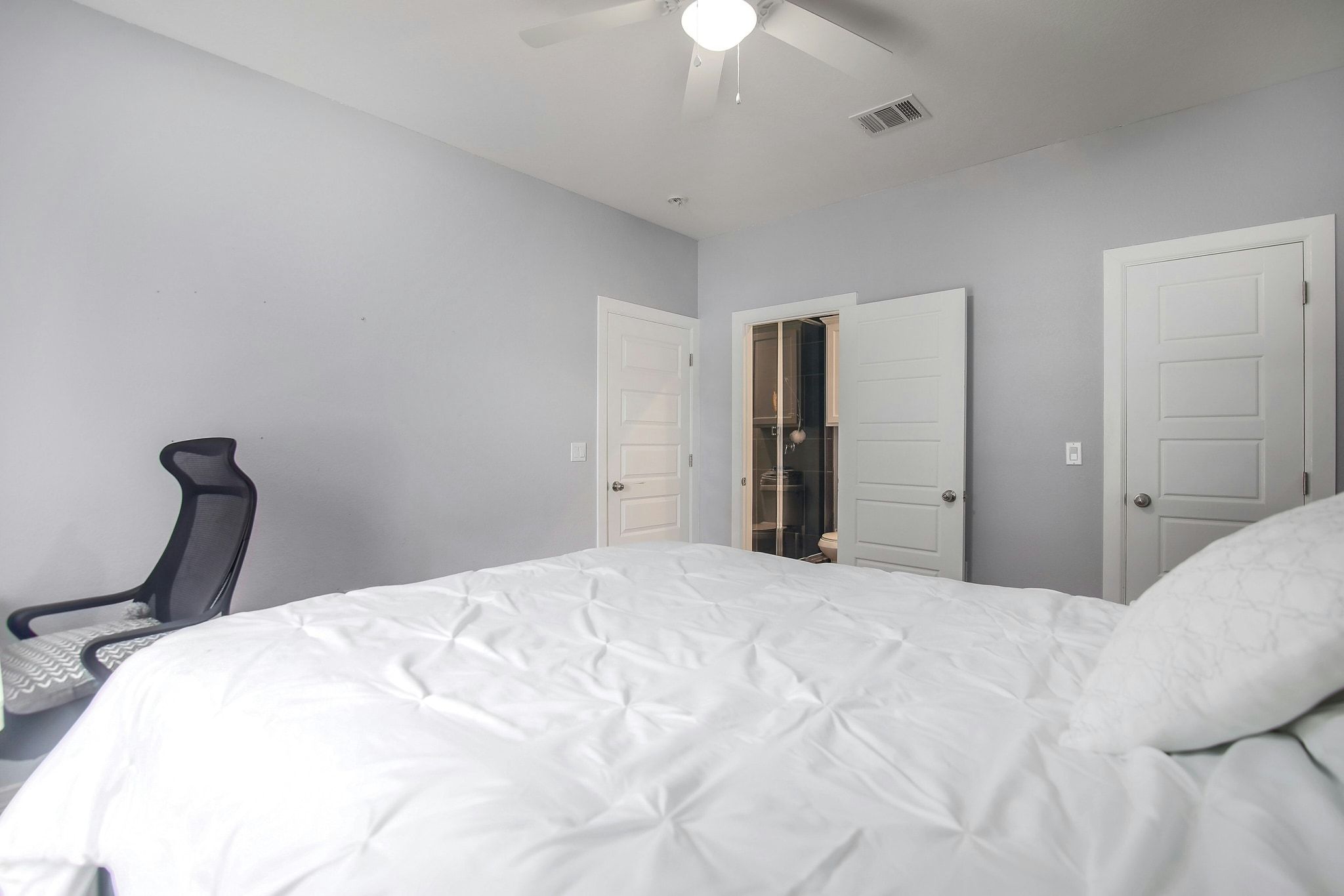 2109 Maxwell Lane, Unit A Austin, TX 78741 - Photo 15 of 27 a bedroom with a bed and a chandelier