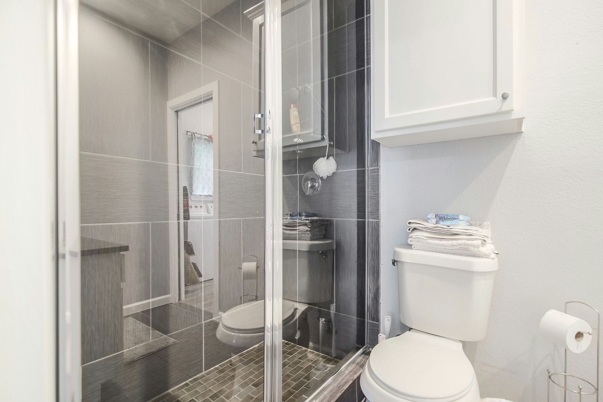 2109 Maxwell Lane, Unit A Austin, TX 78741 - Photo 16 of 27 a white toilet sitting next to a bathroom sink