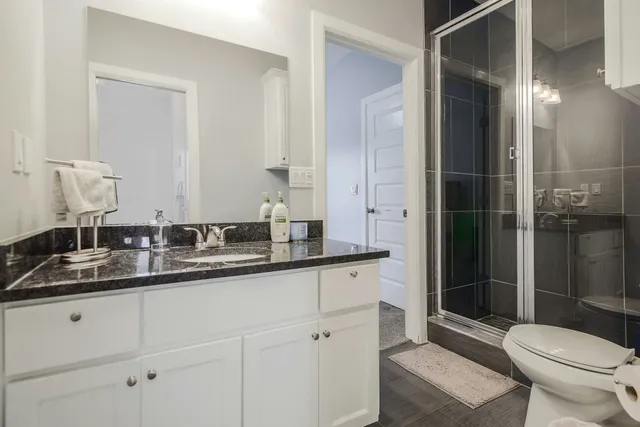 a white toilet sitting next to a bathroom sink
