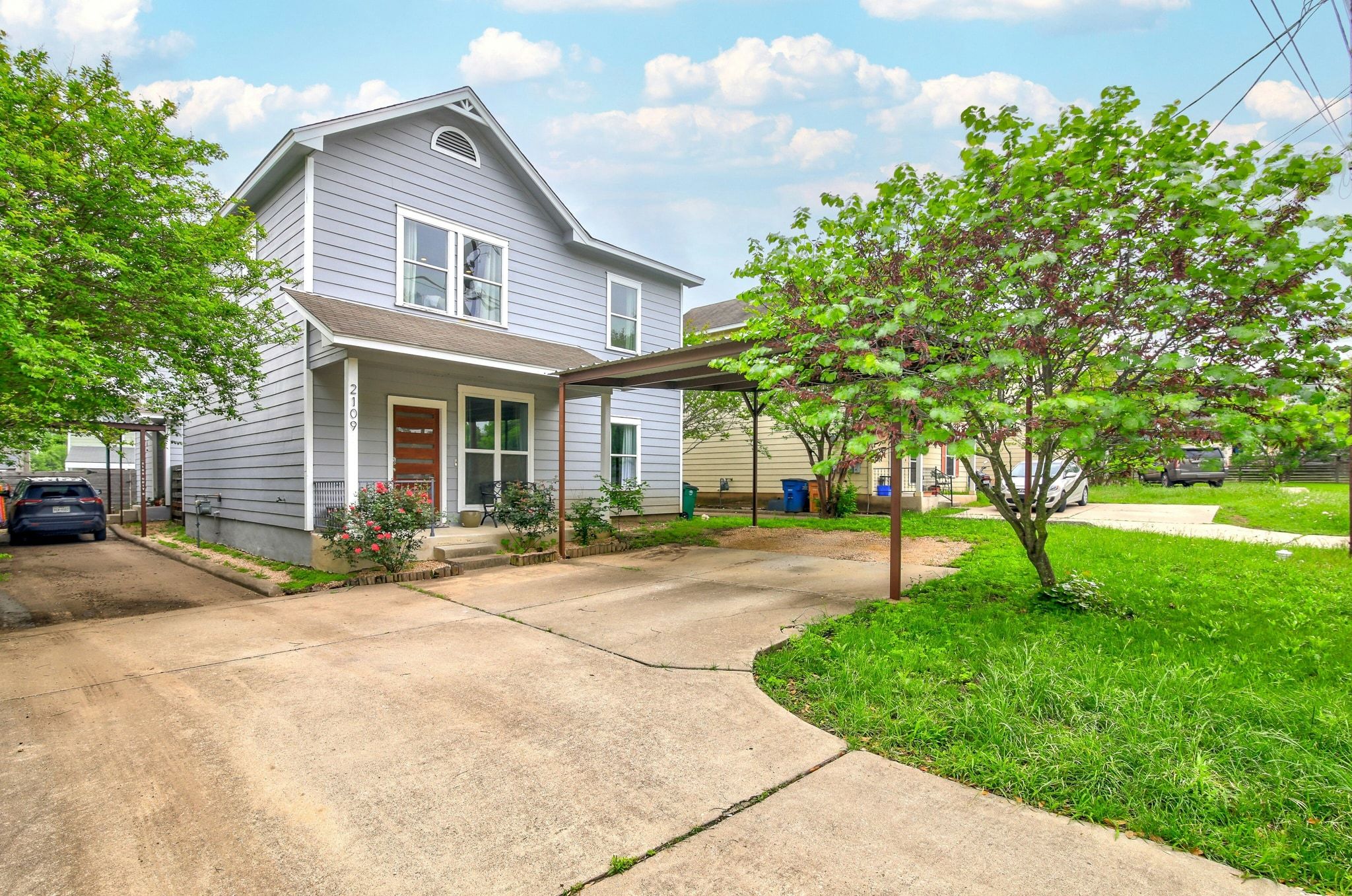 2109 Maxwell Lane, Unit A Austin, TX 78741 - Photo 2 of 27 a front view of a house with a garden and trees