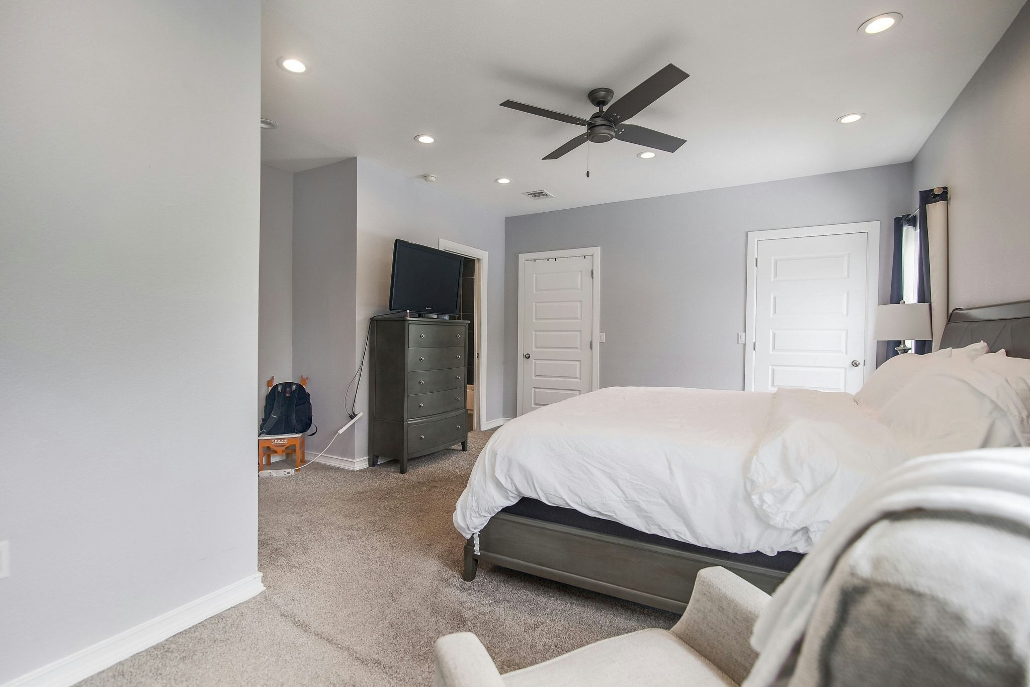 2109 Maxwell Lane, Unit A Austin, TX 78741 - Photo 20 of 27 a bedroom with a bed and a flat screen tv