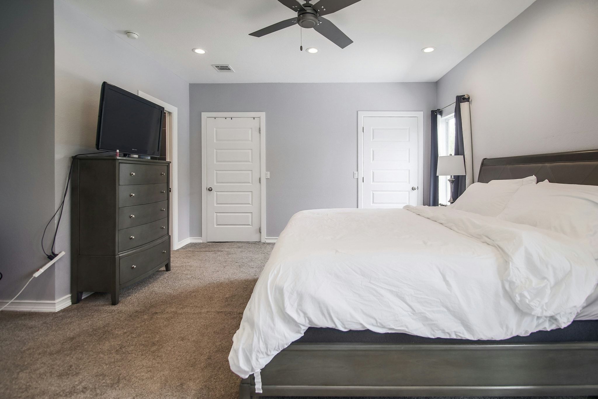 2109 Maxwell Lane, Unit A Austin, TX 78741 - Photo 21 of 27 a bedroom with a bed and a television