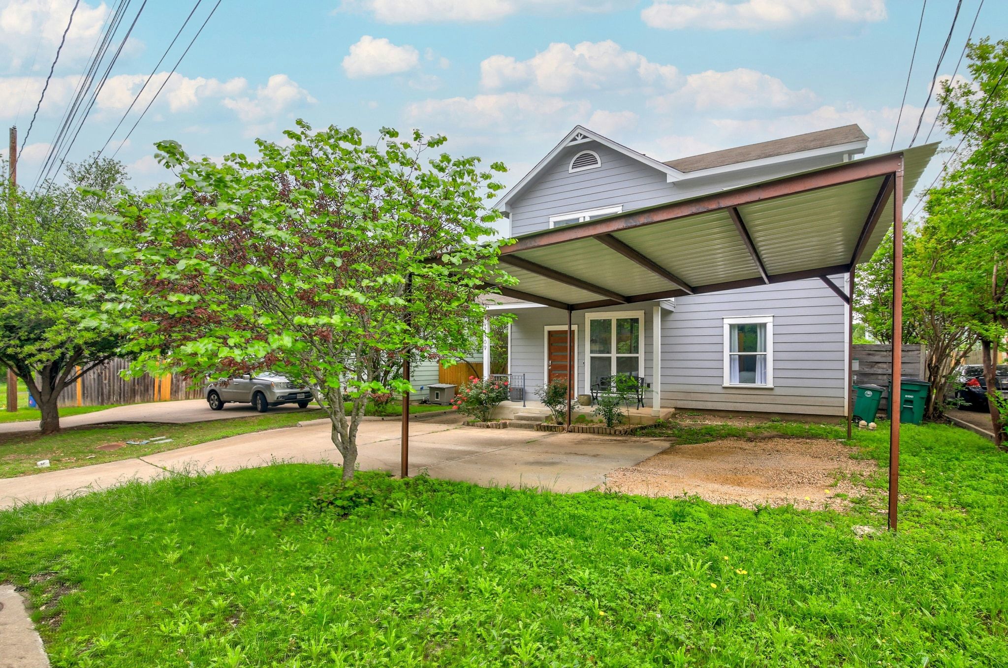 2109 Maxwell Lane, Unit A Austin, TX 78741 - Photo 4 of 27 a view of a patio with table and chairs under an umbrella