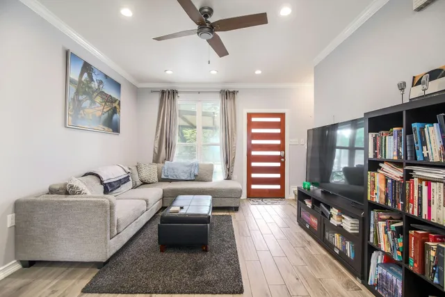 a living room with furniture and a book shelf