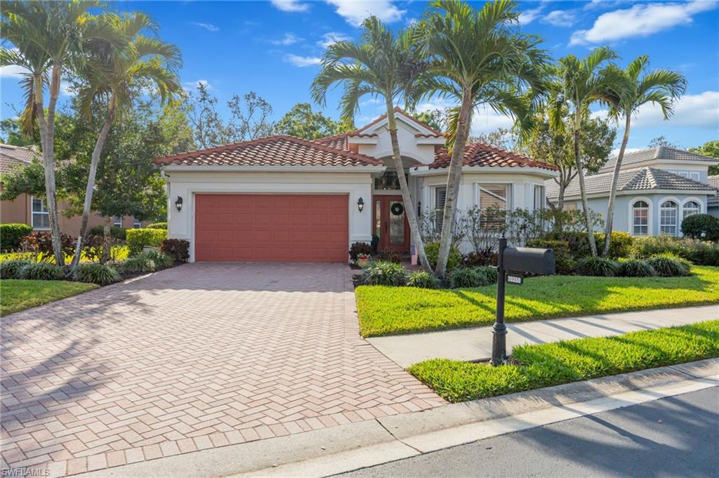 20350 Talon Trace Estero, FL 33928 - Photo 1 of 24 Mediterranean / spanish home featuring decorative driveway, an attached garage, a tile roof, and stucco siding