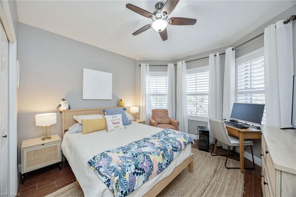 20350 Talon Trace Estero, FL 33928 - Photo 16 of 24 Bedroom with dark wood-style flooring, a ceiling fan, and a desk