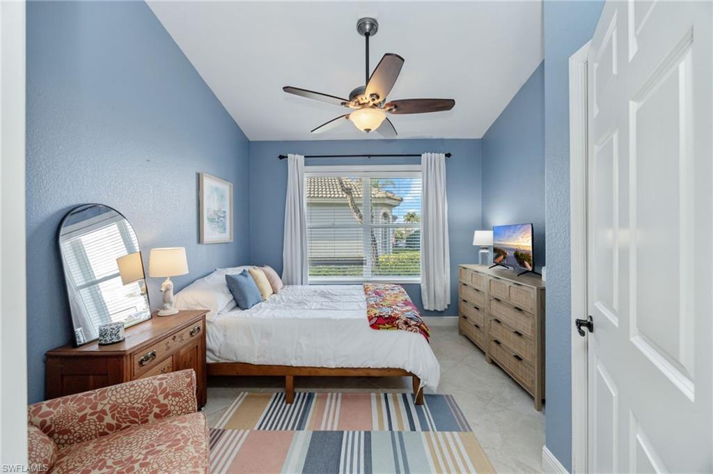 20350 Talon Trace Estero, FL 33928 - Photo 17 of 24 Bedroom with vaulted ceiling, ceiling fan, and a textured wall