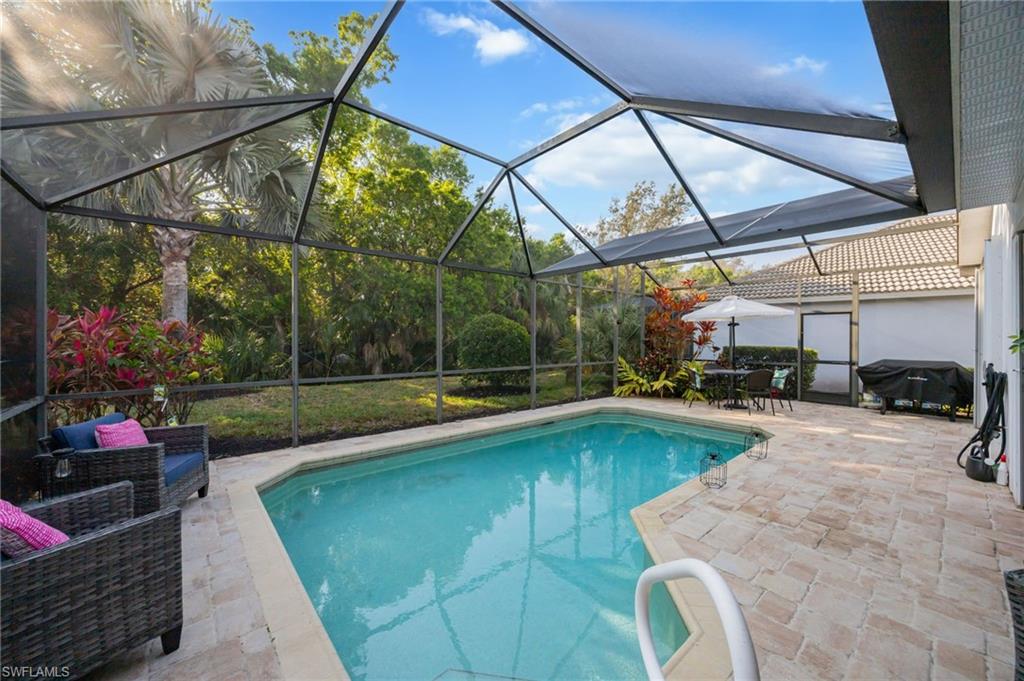 20350 Talon Trace Estero, FL 33928 - Photo 21 of 24 Swimming pool featuring a sunroom, a patio, a lanai, outdoor dining area, and grilling area