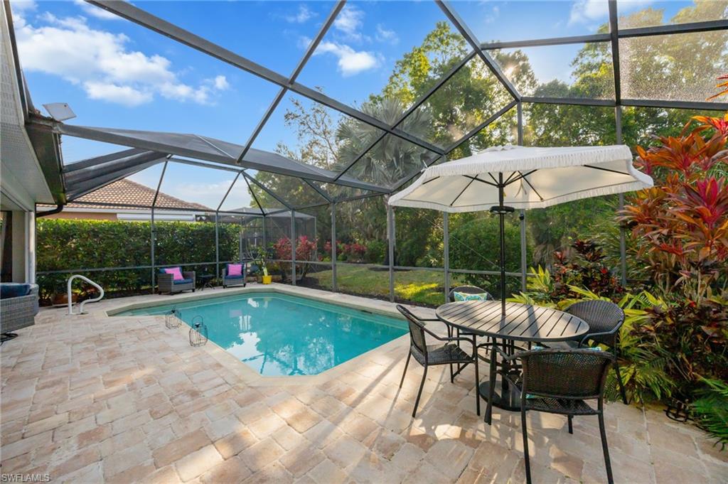 20350 Talon Trace Estero, FL 33928 - Photo 22 of 24 Swimming pool featuring a sunroom, a lanai, outdoor dining space, and a patio
