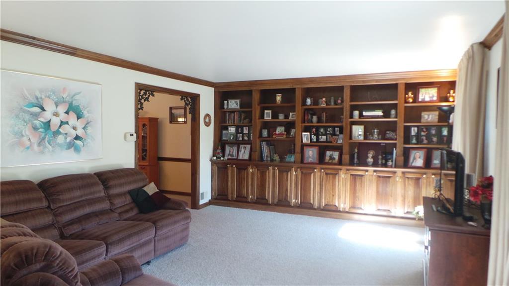 3886 Grove Road Gibsonia, PA 15044 - Photo 3 of 22 Large living room has 2 oversized windows and built in shelves and cabinets.