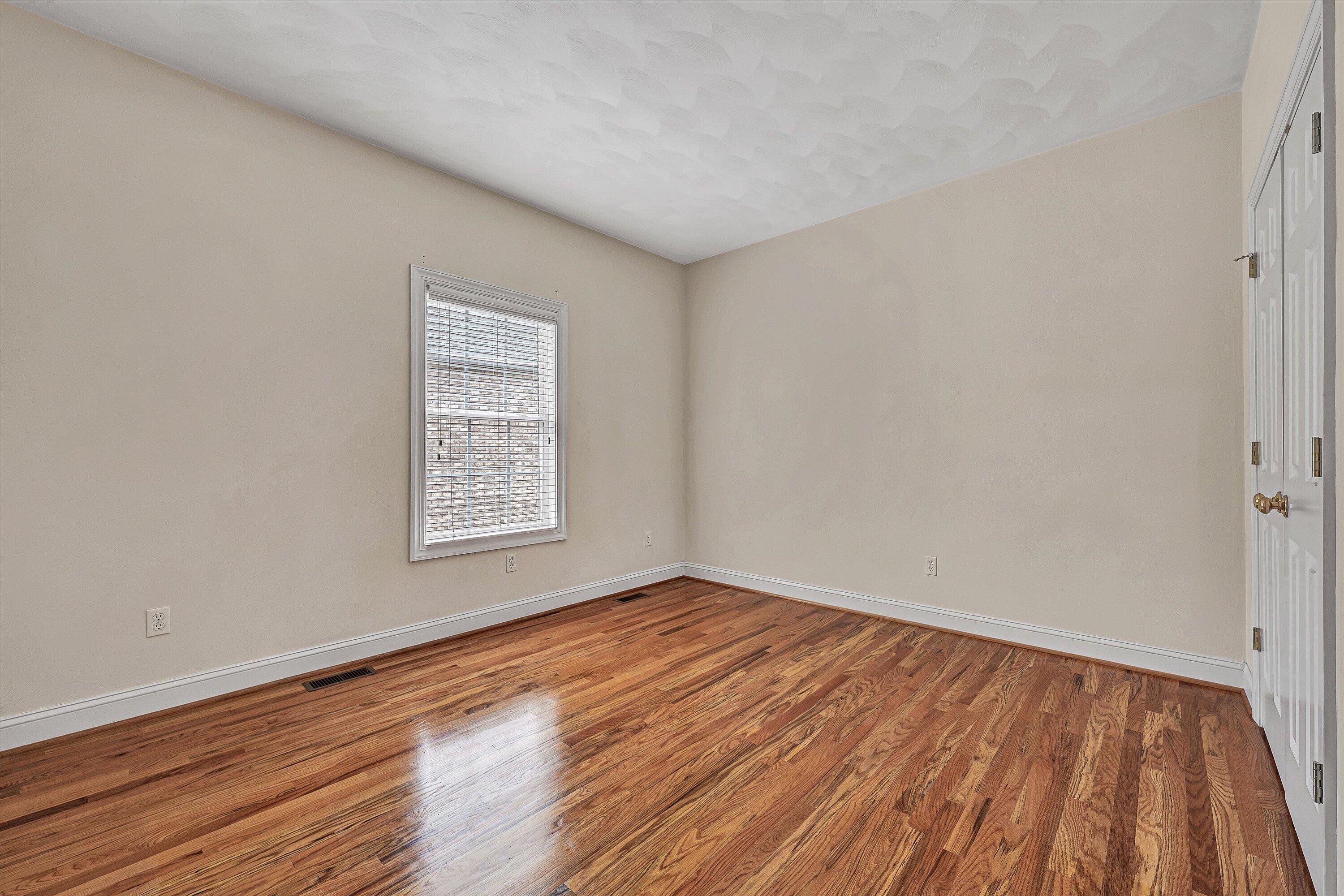 131 Stoney Mill Road Rocky Mount, VA 24151 - Photo 15 of 37 a view of an empty room with wooden floor and a window