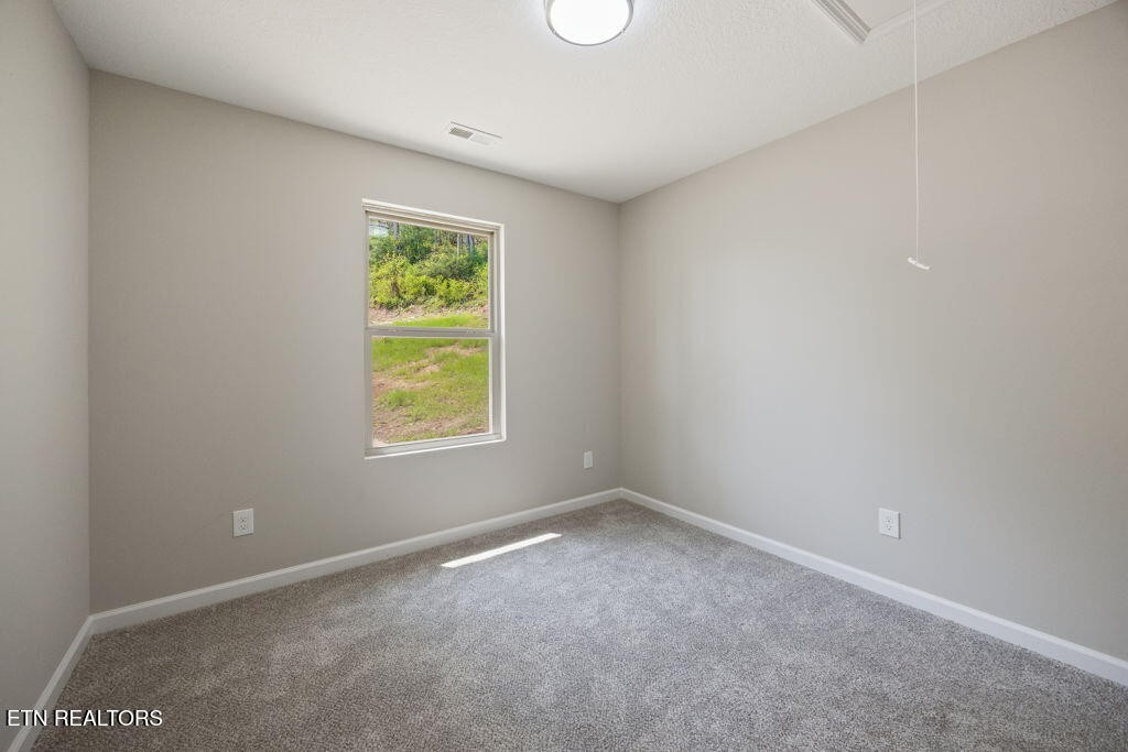 503 Hillcrest Street Clinton, TN 37716 - Photo 12 of 19 a view of an empty room with a window