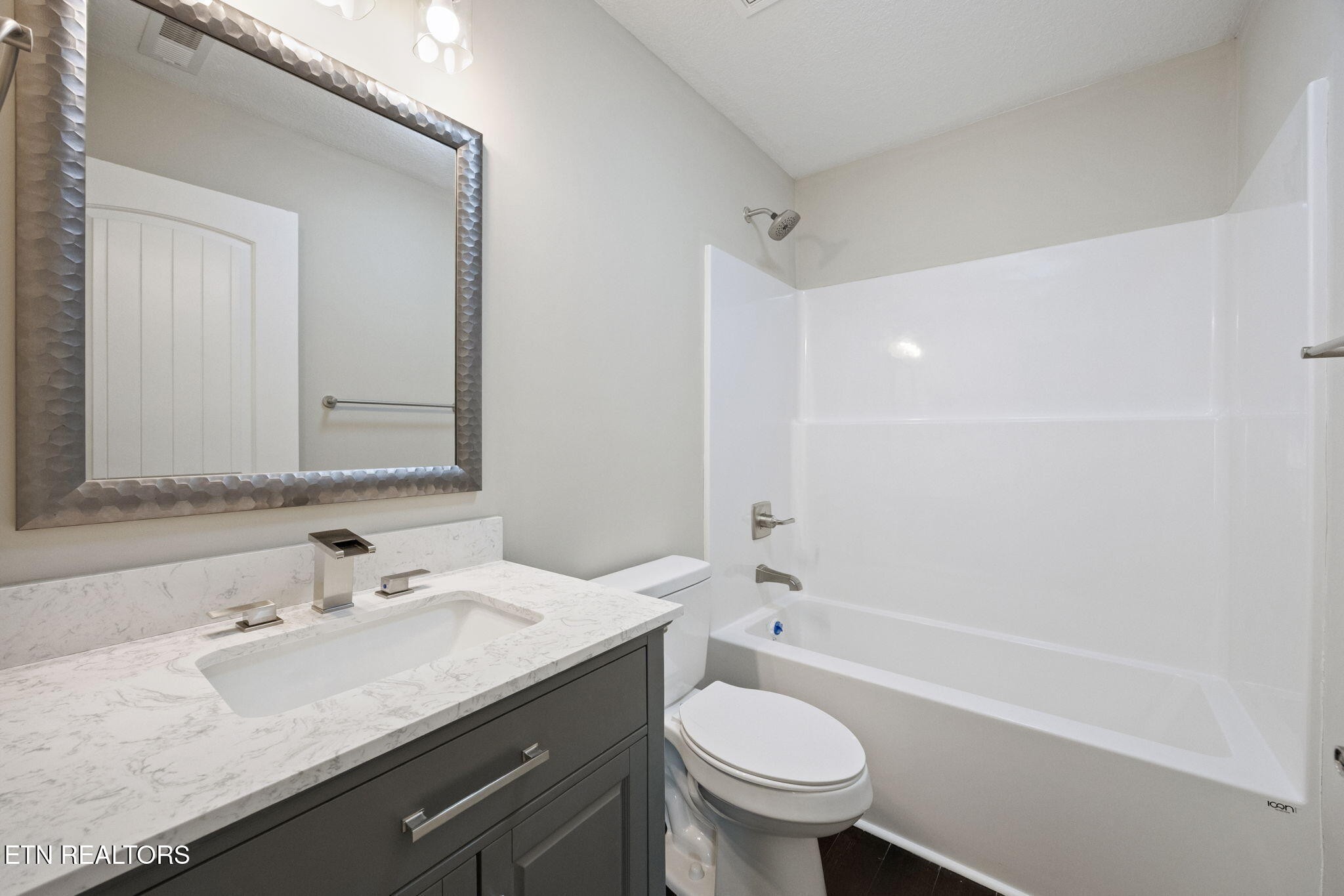 503 Hillcrest Street Clinton, TN 37716 - Photo 13 of 19 a bathroom with a granite countertop sink a toilet and shower